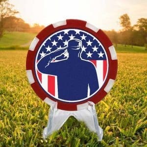 Red and white golf ball marker poker chip featuring a silhouette of an Amercain veteran, standing tall and saluting the American flag.