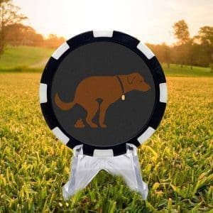 Black and white golf ball marker poker chip featuring a brown dog in the midgst of dropping a deuce against a gray background.