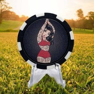 Poker chip style golf ball marker featuring a black and white border with a tattoed pinup girl in a red bikini against a black background.