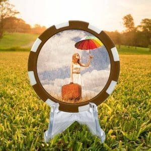 Umbrella Dreams brown and white poker chip style golf ball marker.